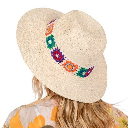 Wide-brimmed straw sun hat with vibrant floral embroidery.