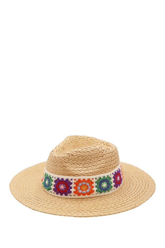 Straw sun hat featuring bright, intricate embroidery.