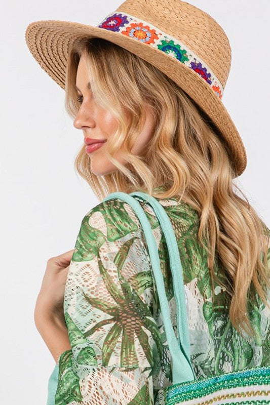 Floral embroidered straw hat for stylish sun protection.