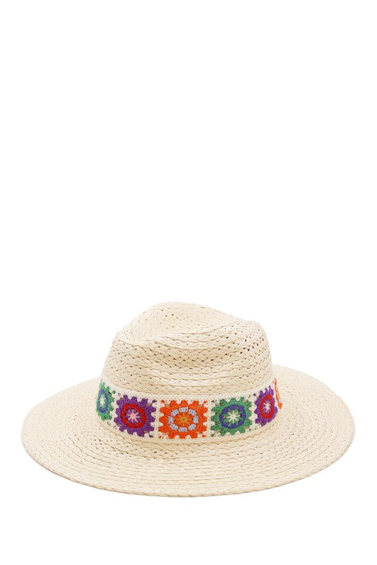 Lightweight straw hat with multicolored embroidery details.