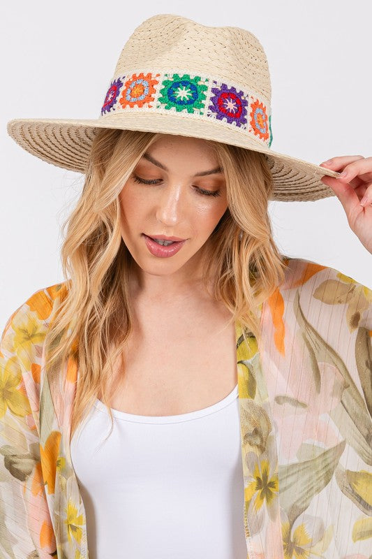 Vibrant embroidered straw hat with a wide brim.