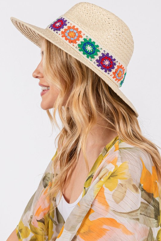 Chic straw sun hat with decorative embroidery.