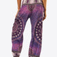 Vibrant purple boho harem pants with intricate patterns.