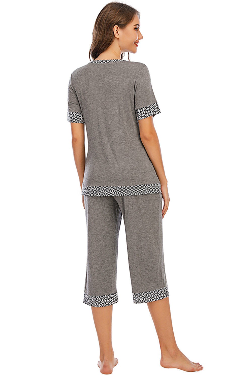 Experience cozy chic with our Round Neck Capri Lounge Set. Perfect for stylish comfort at home or out. Available in gray, navy, and red.