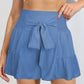Chic sky blue high-rise shorts with a flattering smocked waistband and tie-front. Perfect for a stylish, comfy summer look.