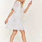 Flowy white boho dress with a tiered design, perfect for casual outings.