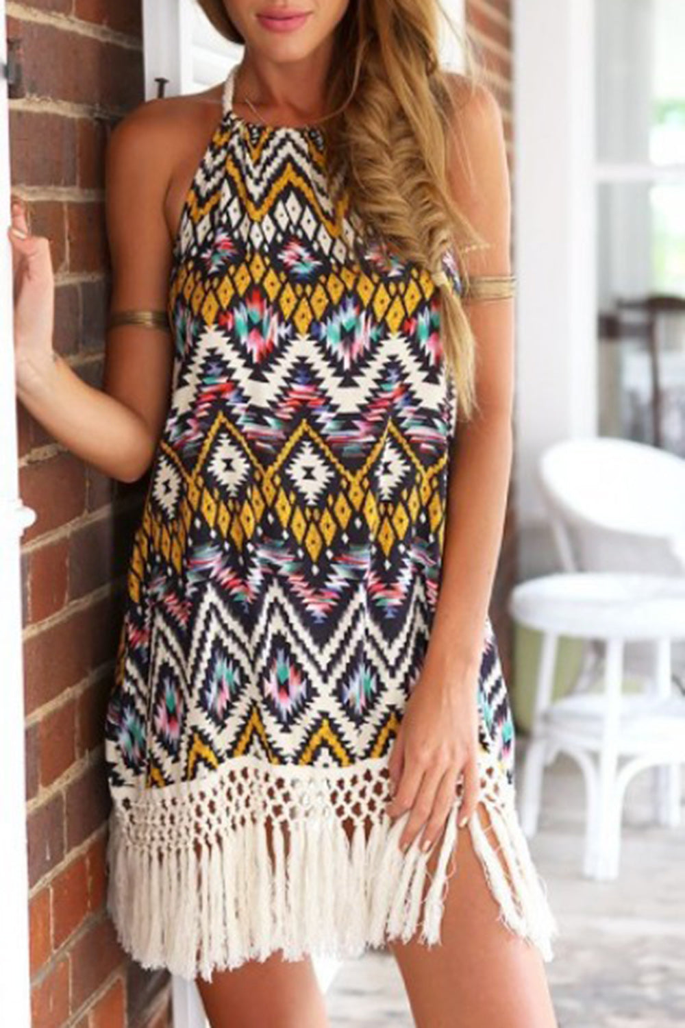 Stylish halter neck mini dress with vibrant print and playful tassels, perfect for any occasion. Chic, comfortable, and versatile.