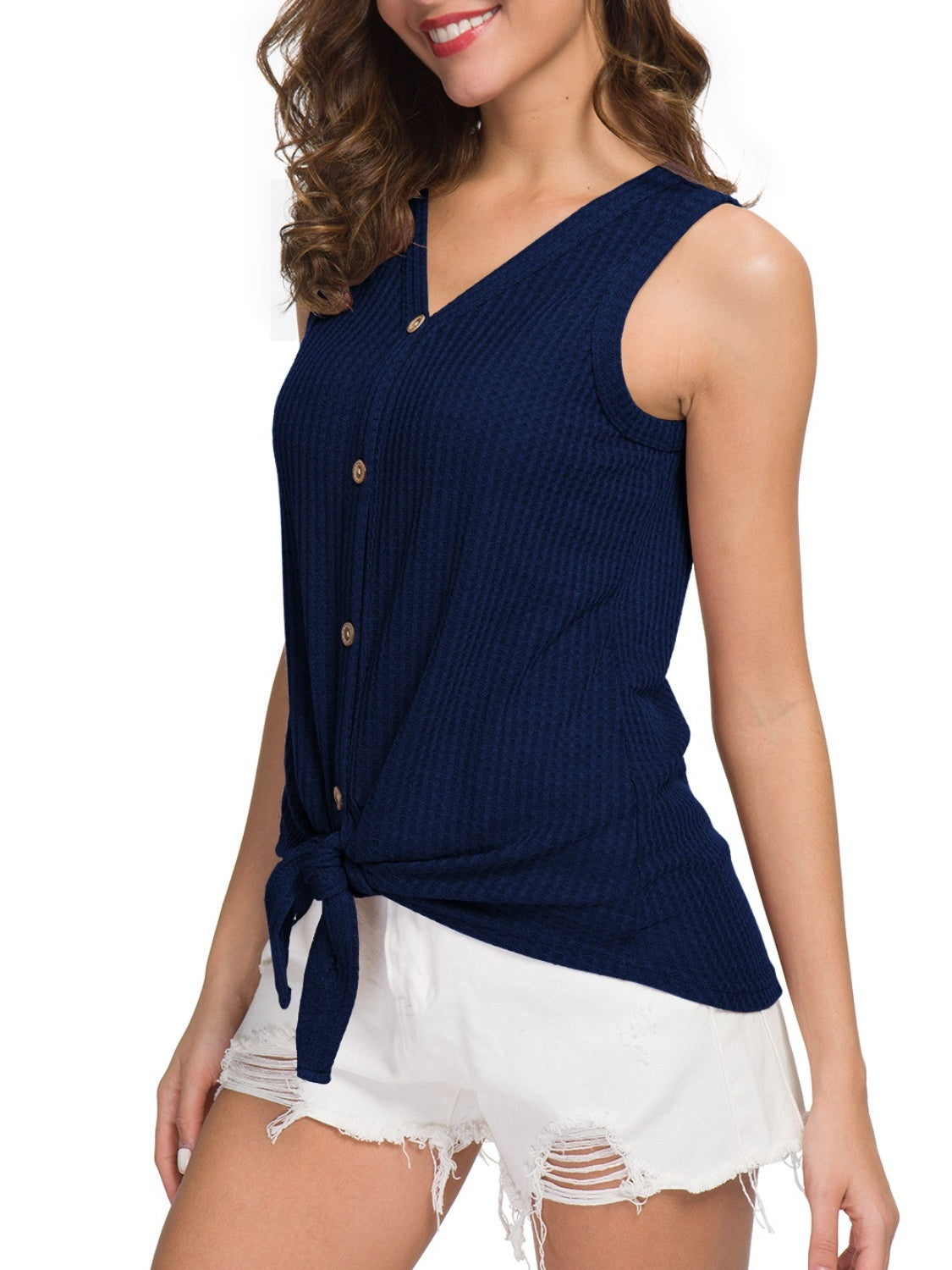 Front view of navy sleeveless top with button-down and tie design