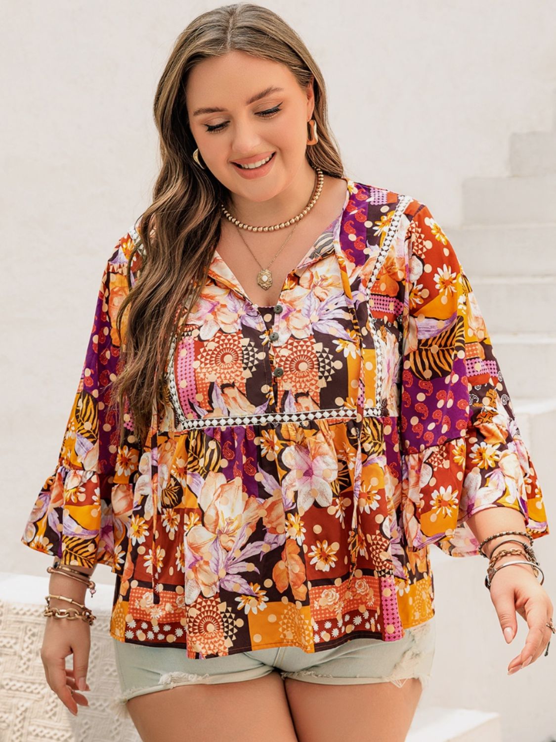 Model in a boho floral blouse, perfect for casual outings.
