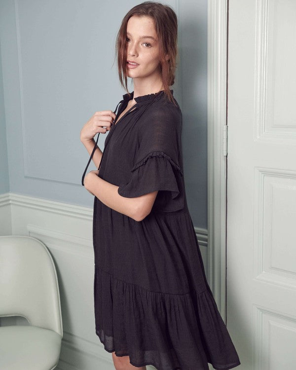 Flowy black boho dress with a tiered design, perfect for casual outings.