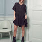 Black boho dress with a tiered silhouette and feminine ruffled sleeves.