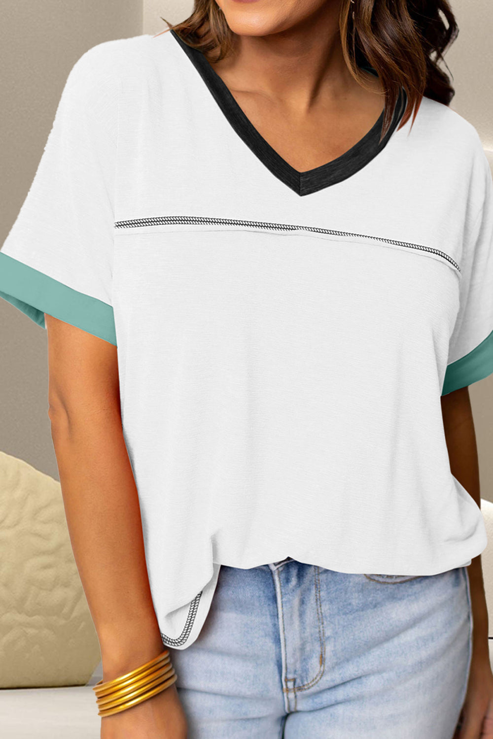 White V-neck tee with contrasting black trim and aqua sleeves.