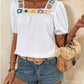 white blouse with short puff sleeves and a colorful crochet square neckline, featuring a relaxed fit perfect for a casual summer look