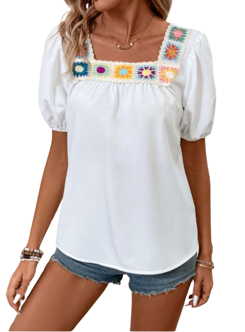 white blouse with short puff sleeves and a colorful crochet square neckline, featuring a relaxed fit perfect for a casual summer look