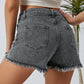Chic distressed denim shorts with a raw hem, perfect for summer. Versatile, comfortable, and effortlessly stylish for any casual occasion.