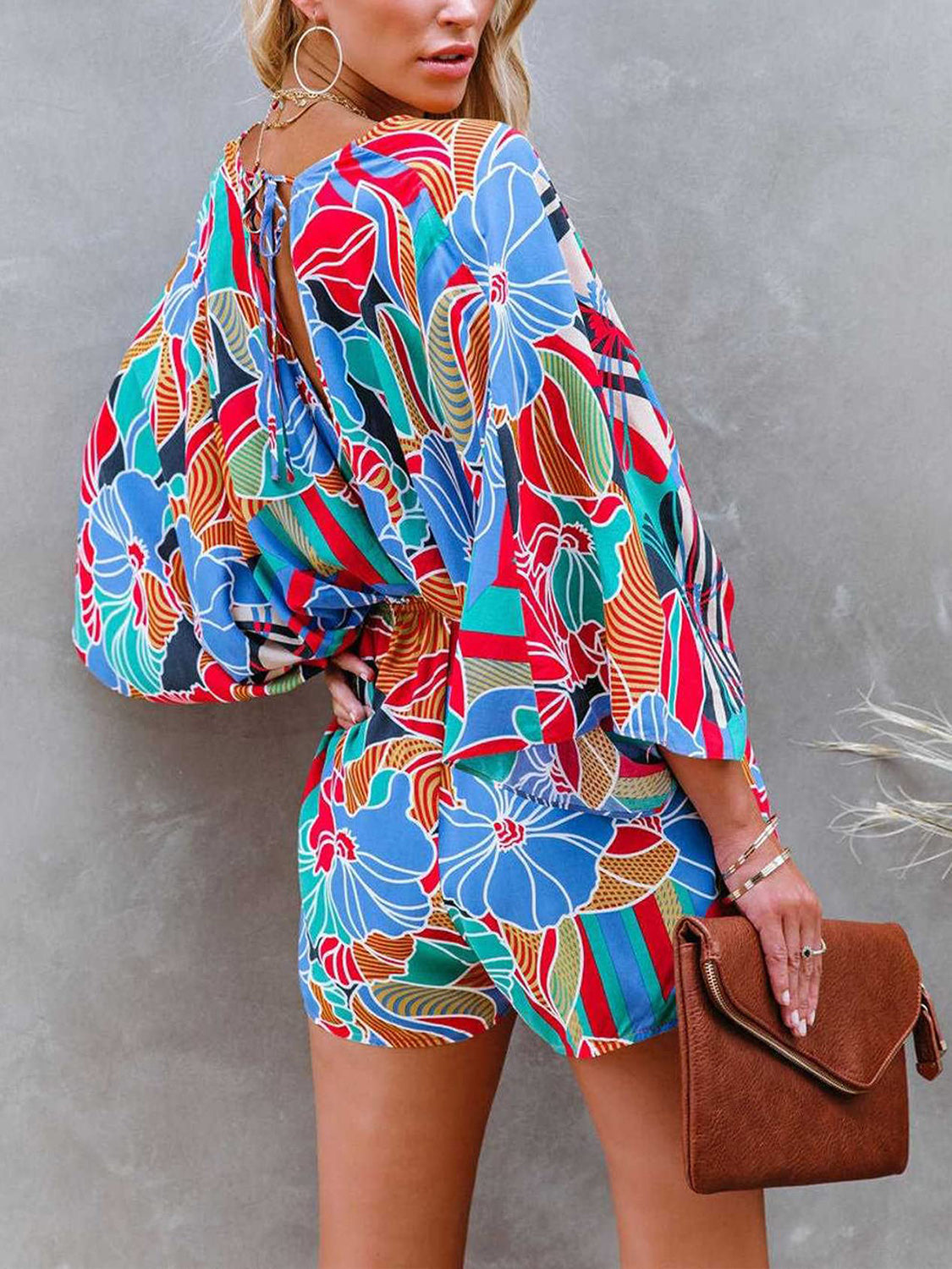 Step into summer with flair in our Tied Printed Kimono Sleeve Romper - perfect for any occasion with a striking, adjustable design