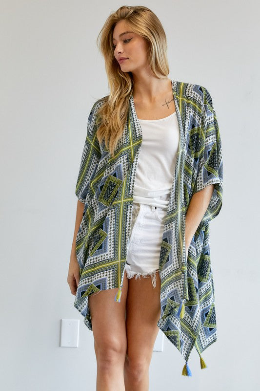 Sheer kimono featuring intricate blue and green designs