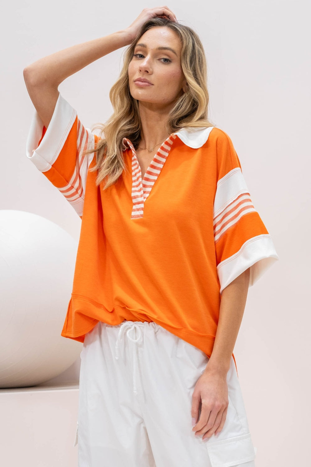 Casual orange top with white and orange striped details