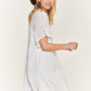 Casual white boho dress with a tiered design and ruffled sleeves.