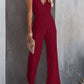 Elegant lace jumpsuit with V-neck and spaghetti straps in white, black, navy, and wine. Perfect for versatile, stylish comfort.