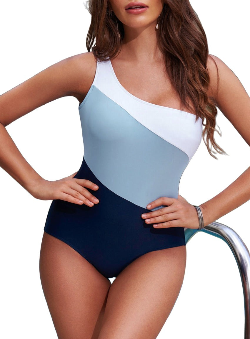 Asymmetrical one piece swimsuit in white, light blue, and navy color block design