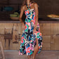 Vibrant floral print halter maxi dress with a tie neck and flowy silhouette.