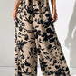 Upgrade your style effortlessly with our Printed Tied Wide Leg Pants. Chic, comfortable, and versatile - perfect for any occasion. Shop now!