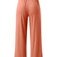 Wide-leg pants with a relaxed fit and adjustable waist in different colors.