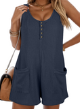 Chic waffle-knit romper with a flattering scoop neck, wide straps, and pockets for stylish comfort and versatility.