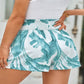 Shop tropical-print smocked waist shorts with convenient pockets for a comfy, chic look. Perfect for sunny days and casual outings!