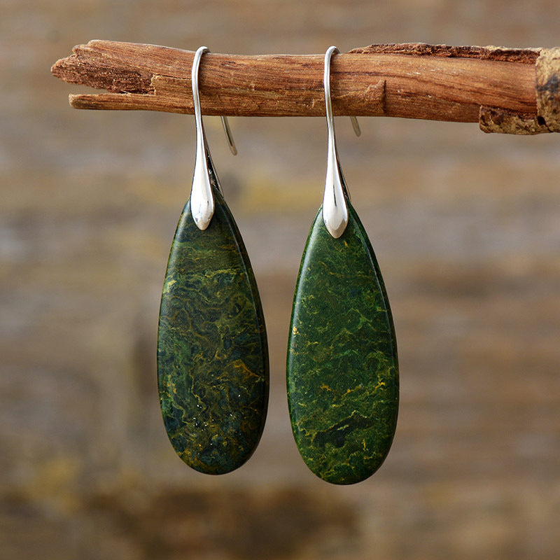 Elegant green stone teardrop earrings with silver accents.