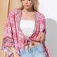 Pink floral kimono with versatile open or tie front design.