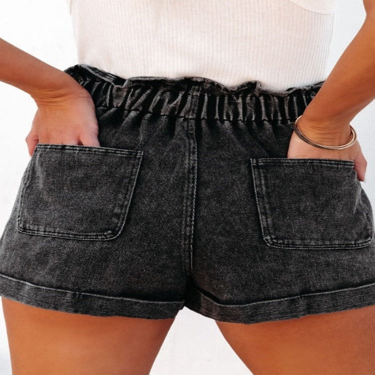 Chic paperbag waist denim shorts with versatile pockets, comfortable fit, and stylish cuffed hem—perfect for any summer look.