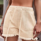 Versatile & stylish Drawstring Denim Shorts with a chic raw hem. Perfect for summer days & available in a variety of colors