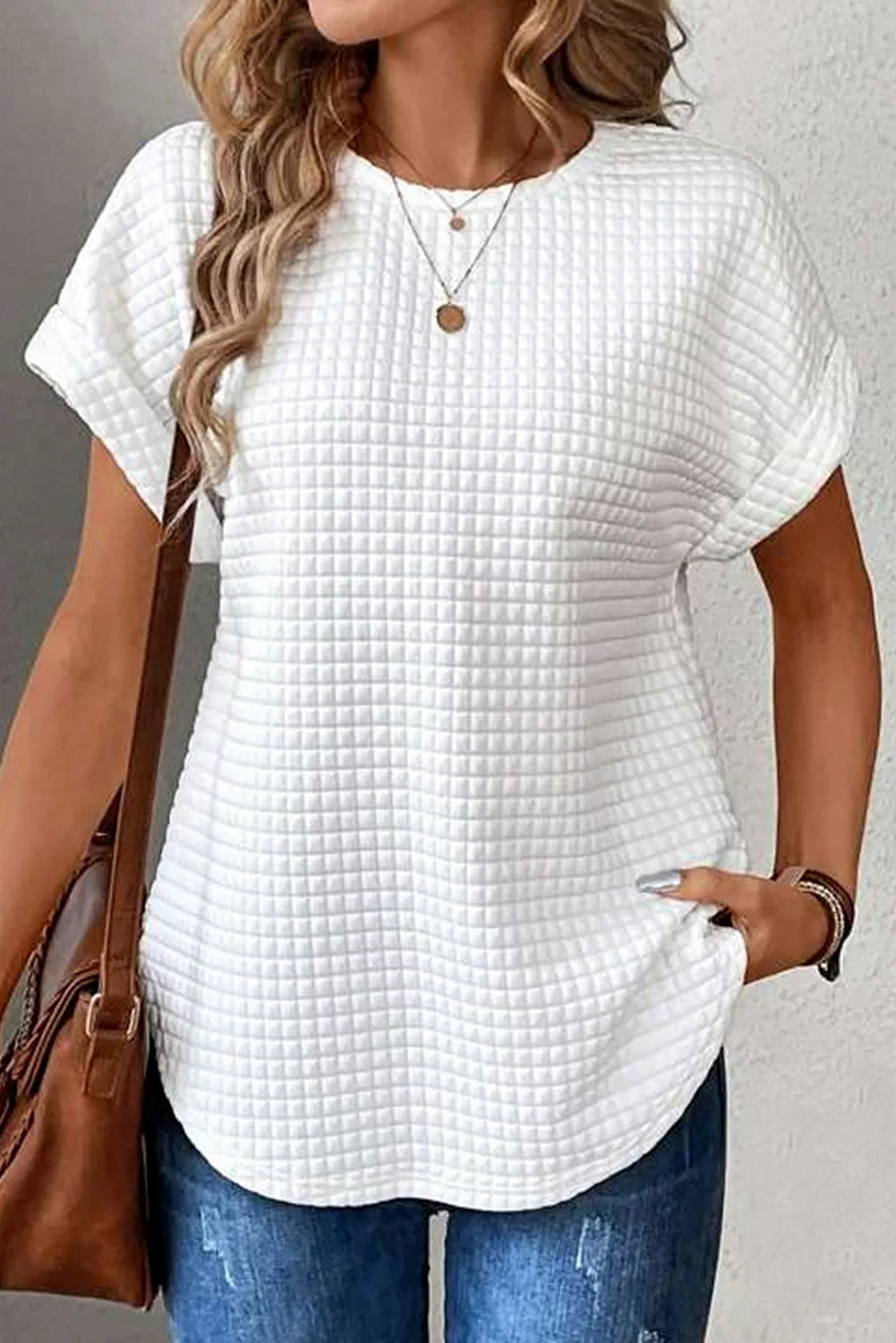 Chic white batwing blouse with a subtle texture, perfect for versatile styling and all-day comfort. A timeless addition to your wardrobe.