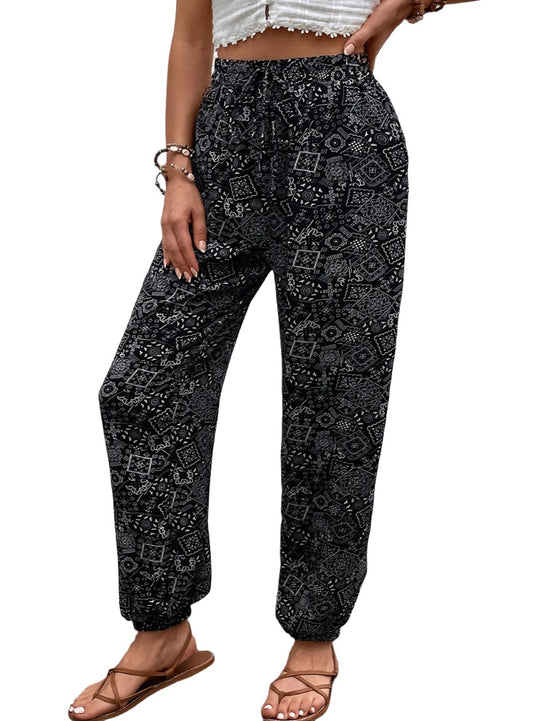 Black bohemian print drawstring pants with elastic cuffs.