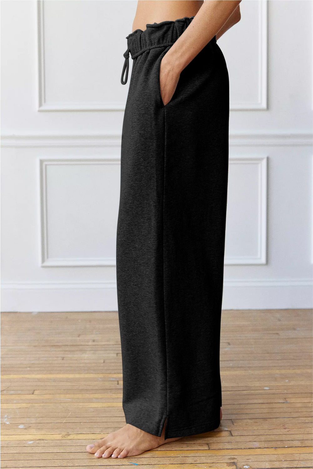 Black wide-leg lounge pants with a stretchy waistband and drawstring.