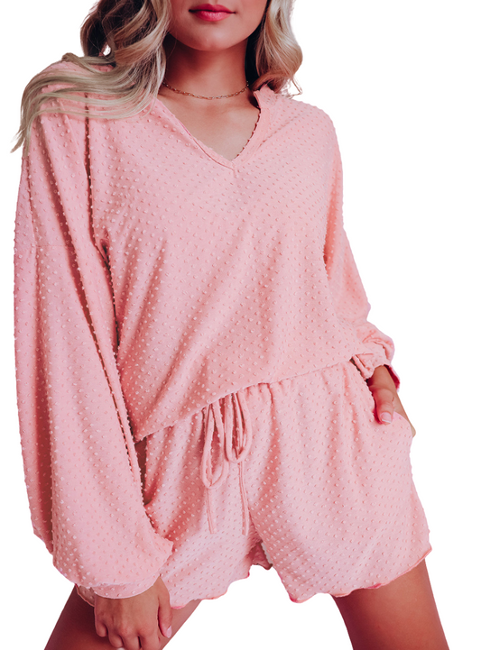 "Chic pink polka-dot loungewear set, featuring a comfy V-neck top and matching shorts with a drawstring waist for a relaxed fit