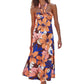 Vibrant floral print halter maxi dress with a tie neck and flowy silhouette.