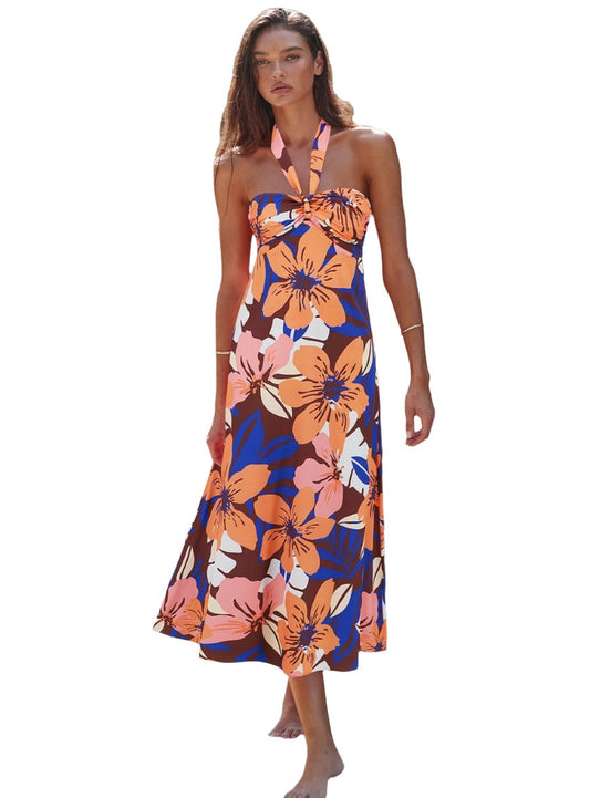 Vibrant floral print halter maxi dress with a tie neck and flowy silhouette.