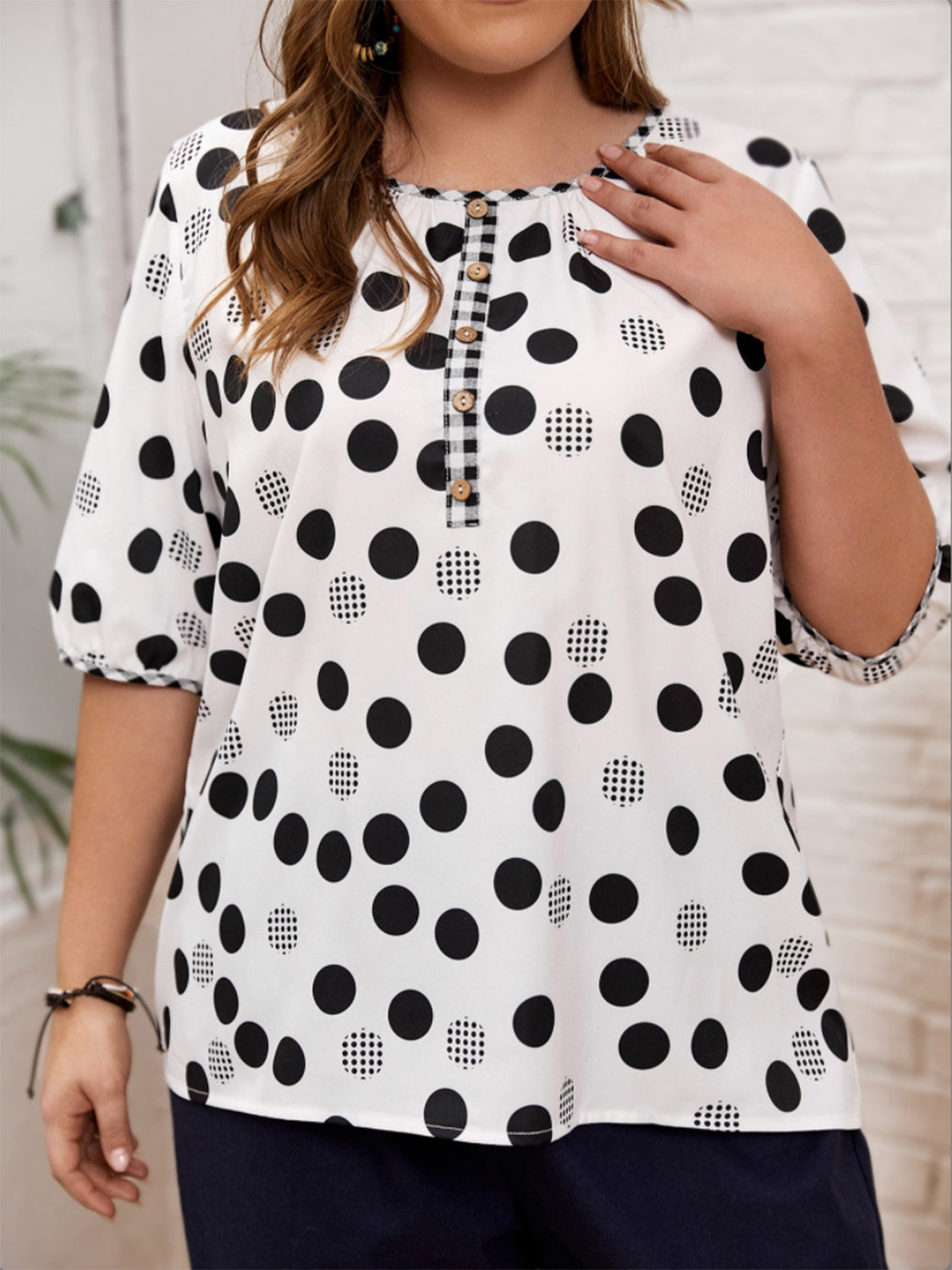 Black and white polka dot blouse with unique checkered button detail