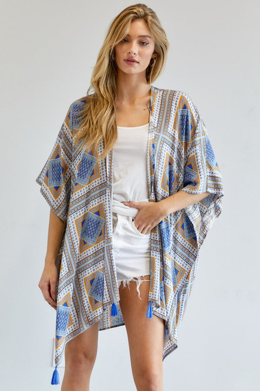 Flowy geometric print kimono with tassel accents, available in yellow and blue