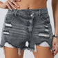 Chic distressed denim shorts with a raw hem, perfect for summer. Versatile, comfortable, and effortlessly stylish for any casual occasion.