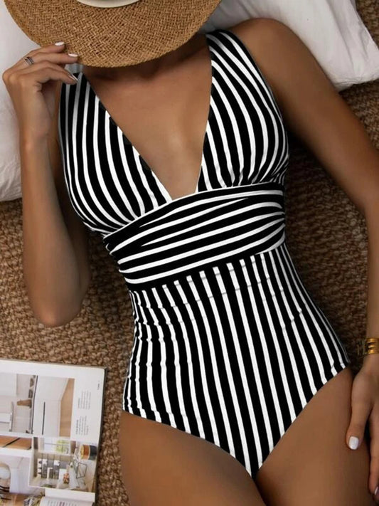 Discover your beach-ready look with our chic striped one-piece swimsuit. Featuring a flattering V-neck and stylish design, it's perfect for any summer outing.