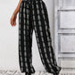 Black boho chic drawstring pants with intricate pattern