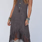 Boho-chic sleeveless midi dress with playful tassels, perfect for versatile day-to-night style. Comfort and elegance in one.