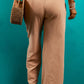 Soft beige pants featuring a drawstring and deep pockets.