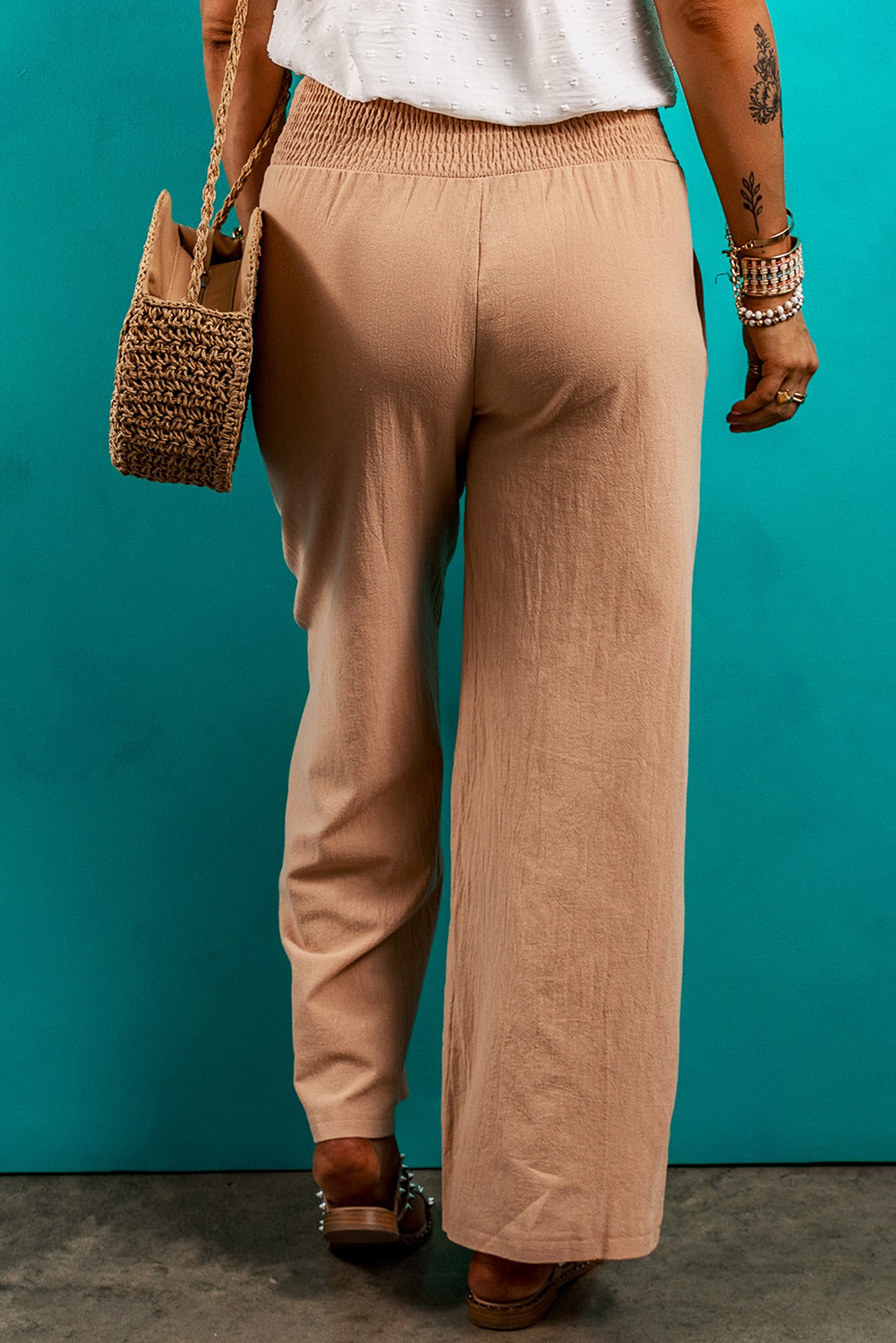 Soft beige pants featuring a drawstring and deep pockets.