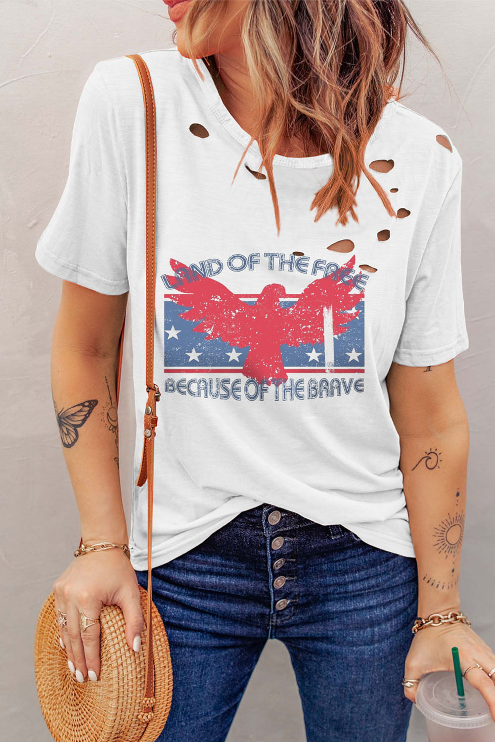 White tee with distressed detailing and bold eagle graphic.