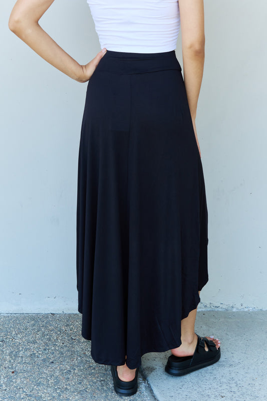 Flowy black skirt with modern asymmetrical design.